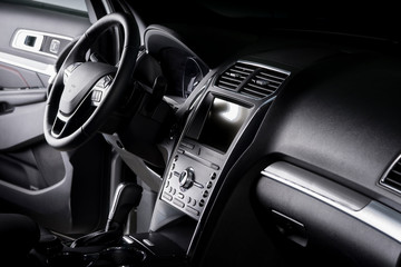 Obraz na płótnie Canvas View of the interior of a SUV car, modern dashboard with touch screen, black leather seats ideal for the driver