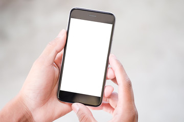 Cropped shot view of man hands holding smart phone with blank copy space screen for your text message or information content, female reading text message on cell telephone during in urban setting.
