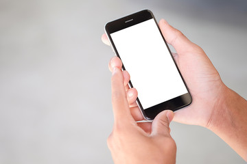 Cropped shot view of man hands holding smart phone with blank copy space screen for your text message or information content, female reading text message on cell telephone during in urban setting.