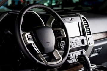 Modern pickup truck interior, touch screen panel, leather seats and automatic transmission lever -...