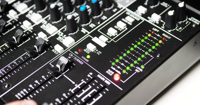 AV Turning Audio Levels Up on Sound Mixer
