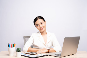 Portrait of a confidence woman sitting at office isolated over background