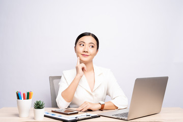 Portrait of a woman has positive thinking sitting at office isolated over background