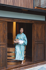 Lifestyle series: Asian woman holding wooden bucket in ryokan