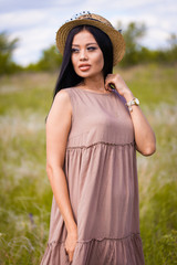 Happy young asian woman in hat on a nature 