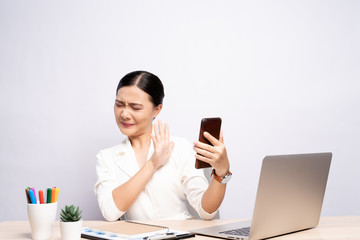 Woman looking at smartphone and feel scared at office isolated over background