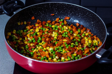 vegetarian stew appetizing colorful dish without meat on a frying pet from corn pepper and peas