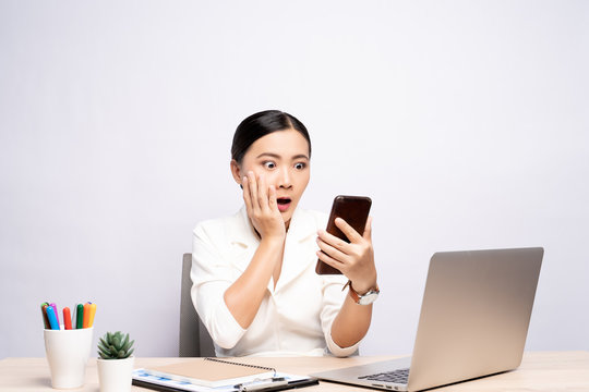 Woman looking at smartphone and feel scared at office isolated over background