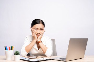 Bored woman at office working with a laptop isolated over background