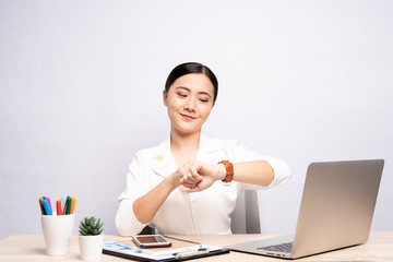 Happy woman holding hand with wrist watch at office isolated over background