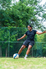 beautiful sporty indian athlete woman playing football