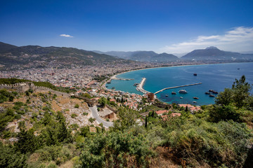 Fototapeta na wymiar Alanya City, Turkey. View from the top observation deck. Quay and Parking for ships.