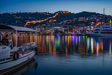 Alanya city, Turkey at night from the pier. Night view of the city of Alanya. Berth for ships.