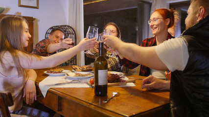 Friends having a party with red wine - cheers