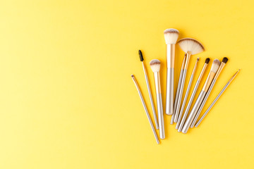 Set of golden makeup brushes with copyspace