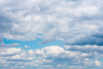 Fototapeta premium Beautiful white cumulonimbus clouds against the background of the bright blue sky