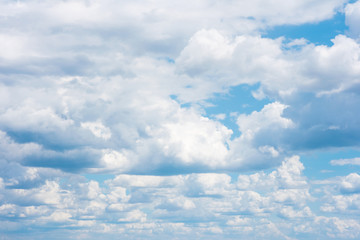 Beautiful white cumulonimbus clouds against the background of the bright blue sky