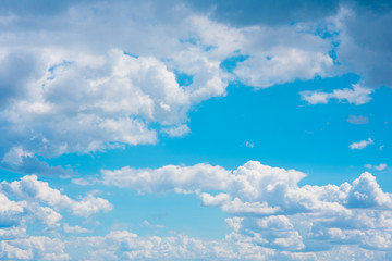 Fototapeta na wymiar Beautiful white cumulonimbus clouds against the background of the bright blue sky