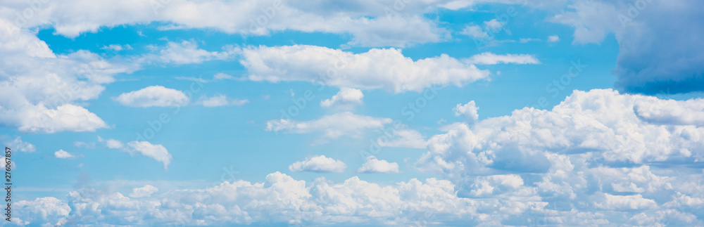 Wall mural Beautiful white cumulonimbus clouds against the background of the bright blue sky