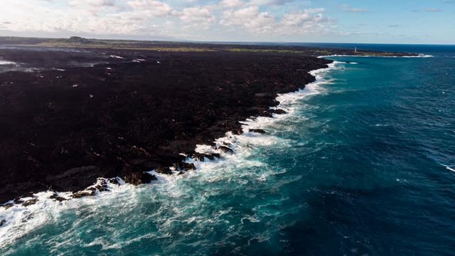 a cinemagraph or animated picture of kapoho bay after the 2018 lava flow that destroyed kapoho beach lots.  steam still drifts months after the flow surface has cooled.