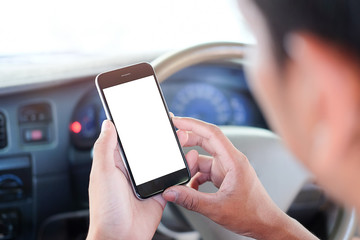 Cropped shot view The driver uses the phone while driving. Modern smart phone with round edges. Isolated screen for mockup. Car navigation display in background. 