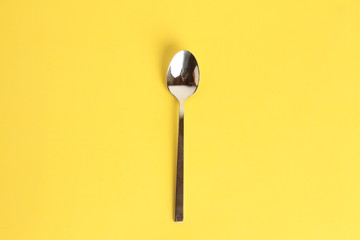 silver spoon isolated on colorful background