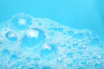 Background soap suds (foam) and bubbles from detergent. House cleaning concept.