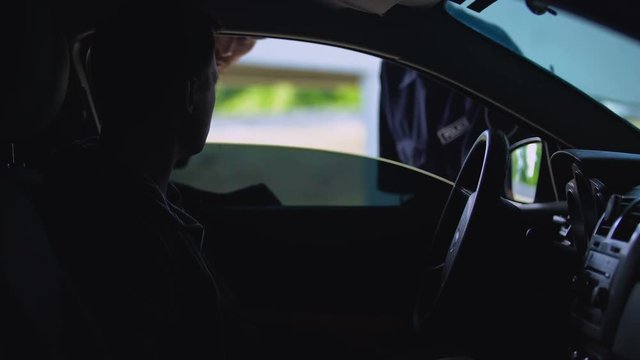 Officers talking to driver in car, road traffic offence suspecting, prevention
