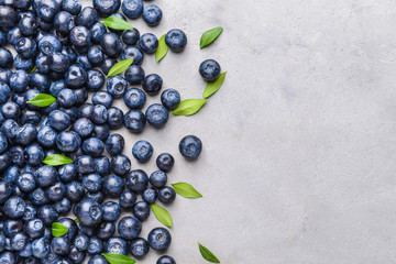 Many ripe blueberry on grey background
