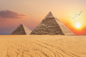 Fototapeta na wymiar The Pyramid of Chephren and the Pyramid of Cheops, beautiful sunset view of Giza, Egypt
