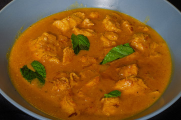 Durban cuisine: A spicy coconut chicken curry. The dish is served with rice and salad and garnished with a few mint leaves
