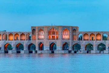 Papier Peint photo Pont Khadjou 22/05/2019 Isfahan, Iran, Khaju Bridge with plenty of people over Zayandeh river is iluminated at dusk with lights, Serving as a dam as well
