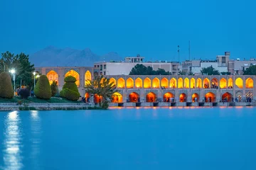Photo sur Plexiglas Pont Khadjou Khaju Bridge with plenty of people over Zayandeh river is iluminated at dusk with lights, Serving as a dam as well