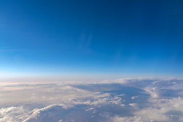 Fototapeta na wymiar View of dark blue sky horizon, up in the air. viewed from an airplane window