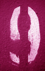 Number 9 in stencil on metal wall in pink tone.