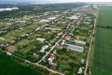 Aerial shoot of the houses of the village. Aerial fly over the village on the countryside