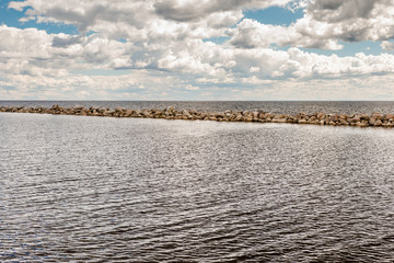 Gulf of Finland and rocks on the shore. Beautiful sky with clouds. Leningrad region, Russia.