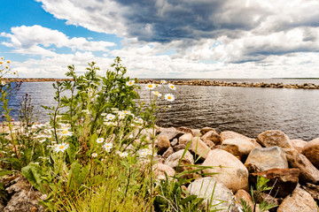 Gulf of Finland and rocks on the shore. Beautiful sky with clouds. Leningrad region, Russia.