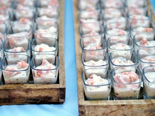 catering banquet table with different food snacks and appetizers in glass on corporate event, christmas, birthday, wedding celebration. Catering, banquet, buffet or party food concept. 