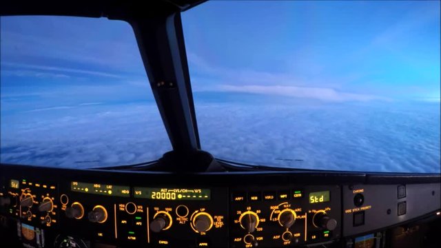 Aircraft flying peacefully over the clouds just before sunrise.