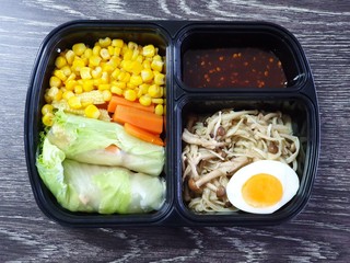 Clean food style, Top view of hydroponic vegetable salad rolled with grilled chicken breasts and carrots with corn, fried mushrooms with butterand, boiled egg and spicy seafood dipping sauce