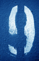 Number 9 in stencil on metal wall in navy blue tone.