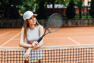 A pretty, young female tennis player serious on court. Sport life..