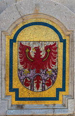 Stone Crest, Emblem, Flag of City Meran on a bridge in the central district. Merano. Province Bolzano, South Tyrol, Italy. Europe.