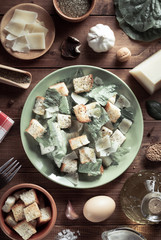 caesar salad in plate at wood