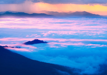 Misty clouds in the mountains at sunrise