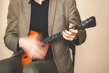 Man fast playing balalaika, close up