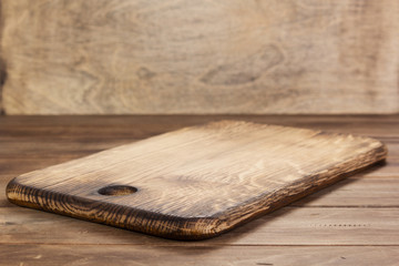 pizza cutting board at rustic wooden table in front