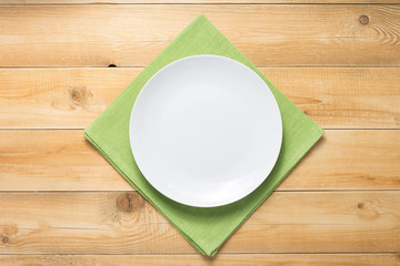 plate and napkin cloth at rustic wooden background