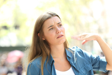 Unhappy woman fanning with the hand suffering heat stroke